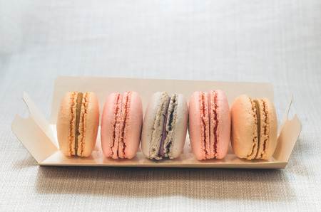 Appetizing cakes macaroons in the package close upの写真素材