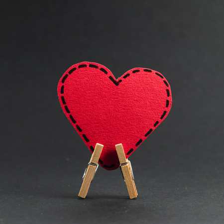 Red heart on the clothespin with the greeting happy Valentines day.の写真素材