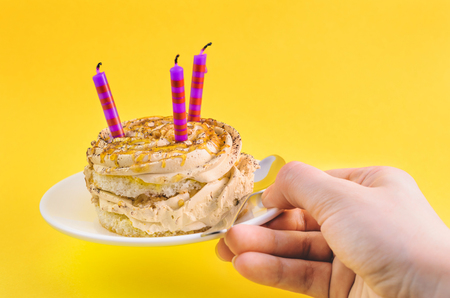 Cake with cream and three candles isolated.の写真素材