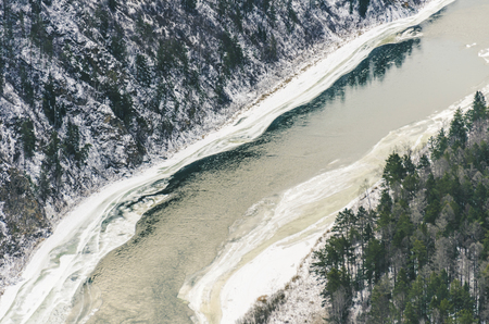 Autumn and winter landscape, the mountain and the river freezesの写真素材