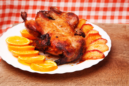 Roast duck with apples and orangesの写真素材