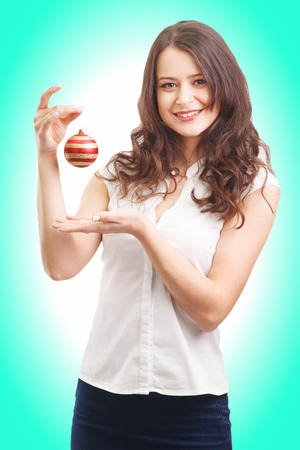 Cute young girl holding christmas toyの写真素材