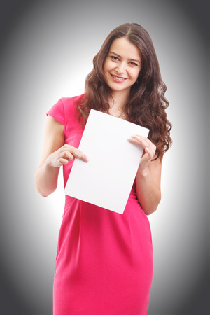 Happy businesswoman holding a white banner and smilingの写真素材