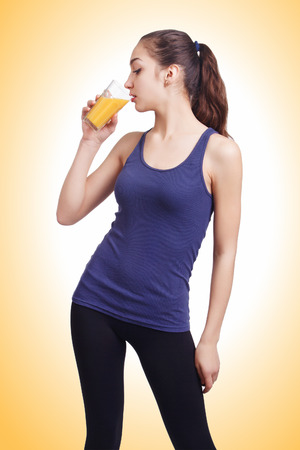 Pretty woman drinking a health drinkの写真素材