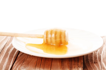 honey is dripping from the spoonの写真素材
