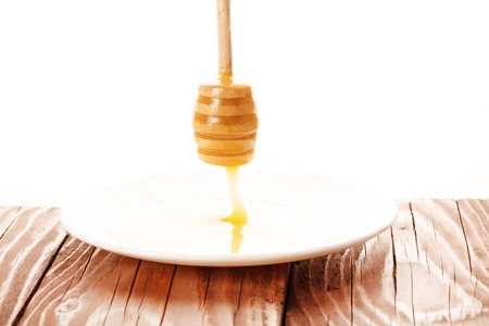 honey is dripping from the spoonの写真素材