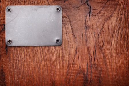 A Wooden background with metal labelの写真素材
