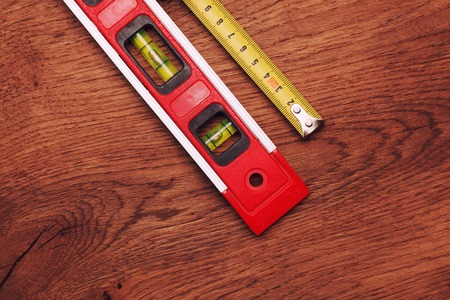 tape measure and building level on wooden backgroundの写真素材