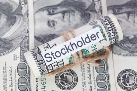 Money and business idea, The dollar bills tied with a rope, with a sign - Stockholder