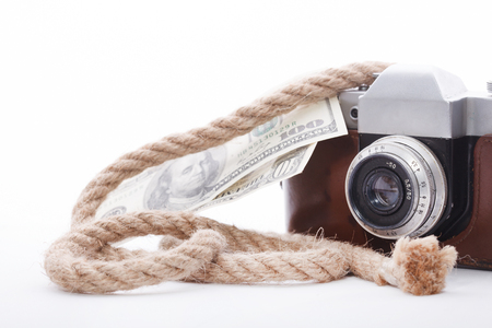 Old camera and money isolated on white backgroundの写真素材