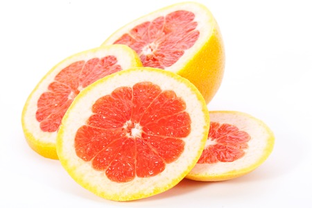 slices of  grapefruit on white backgroundの写真素材
