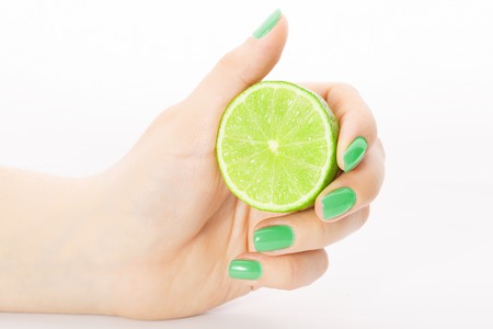Fresh juicy tasty green lime in a Female handの写真素材
