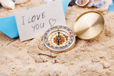 compass in the sand with sign - I love youの写真素材