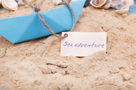 Compass in the sand with Message - Sea adventureの写真素材
