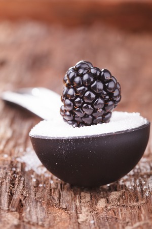 Raspberries in a spoon with Sugarの写真素材