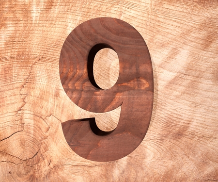 Decorative wooden alphabet digit nine symbol - 9. 3d rendering illustration. Isolated on white backgroundの写真素材