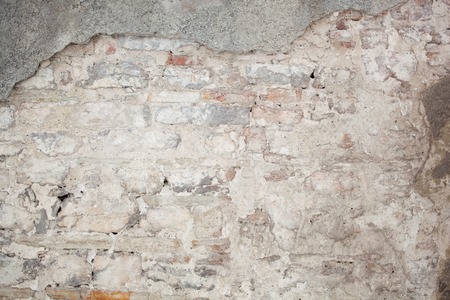 old medieval plaster and brick wall in shadowの写真素材