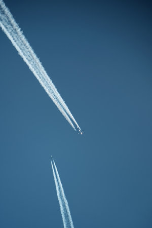 Airplane trails in the blue sky. Airplane trail on blue sky.の写真素材
