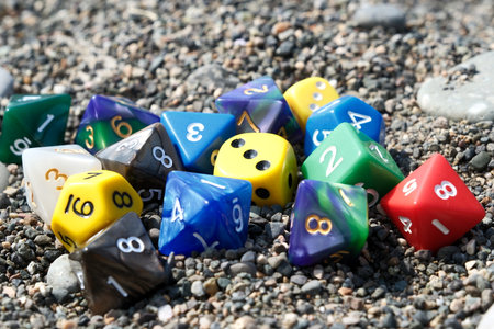 Colorful dice on the beach. Selective focus on dice.の写真素材