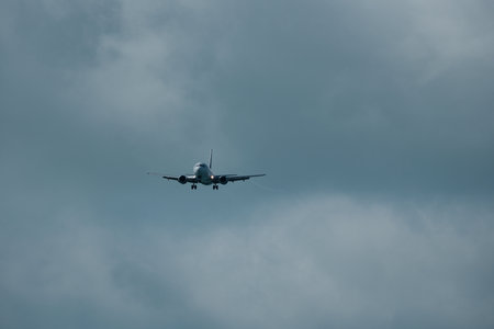 Airplane in the cloudy sky.