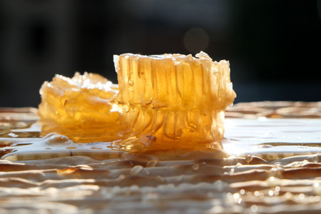 Honeycombs with honey on a wooden table. Shallow depth of field.の写真素材