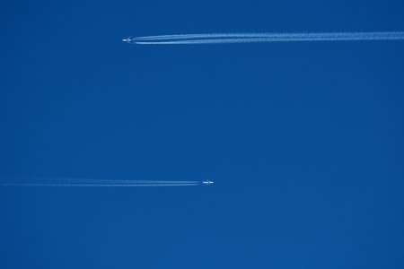 Airplane trail in the blue sky, closeup of photo.の写真素材