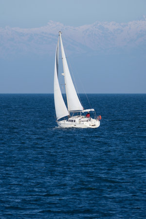 Sailing boat in the sea on a background of blue sky.