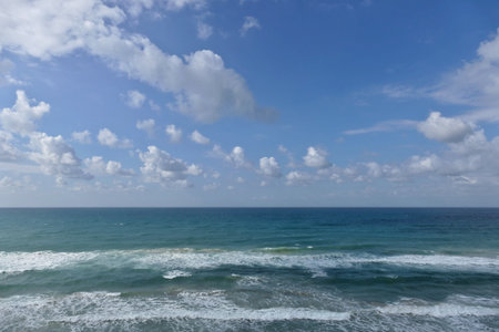 Blue sky with clouds and sea waves on the beach. Beautiful seascape with blue sky and white clouds background.の写真素材