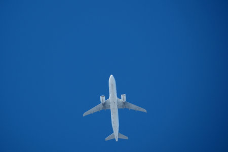 Jet airplane flying overhead in clear blue sky. Airplane in the blue sky.の写真素材