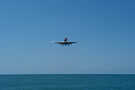Airplane flying over the sea and blue sky in the background.の写真素材