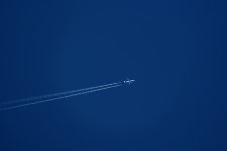 Airplane in the blue sky, close-up of photo.の写真素材