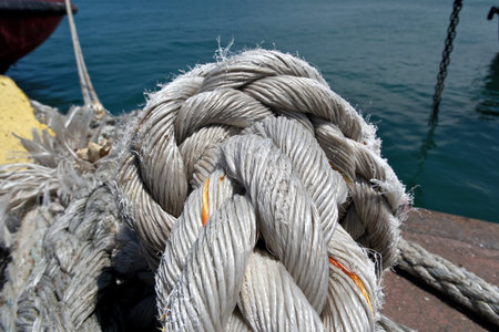 Rope tied to the deck of a ship, closeup of photoの写真素材