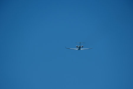 Airplane Takeoff and Climb Against Clear Blue Sky. Dynamic view of a jet aircraft ascending after...