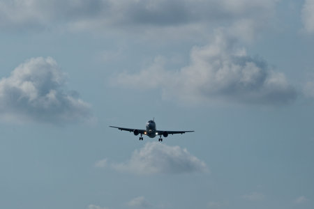 Airplane in the cloudy sky.