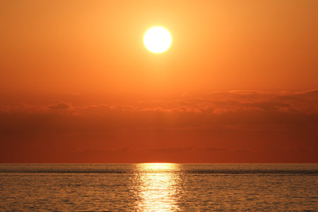 Beautiful sunset over the sea. Sunset over the sea. The sun is reflected in the water.の写真素材