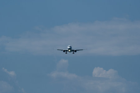 Airplane in the cloudy sky. An approaching airplane against a backdrop of clouds.