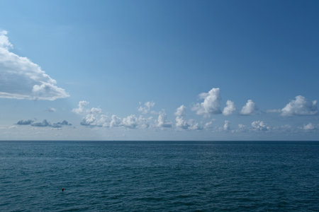 Blue sky with white clouds over the sea. Natural background, copy space.の写真素材
