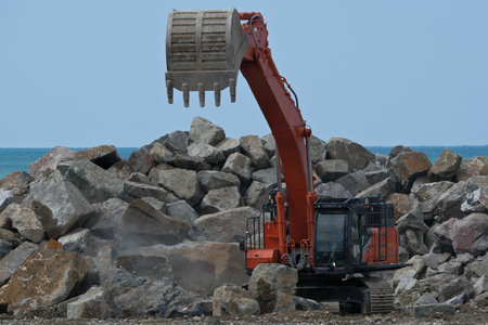 excavator at work on the seashore, closeup of photo