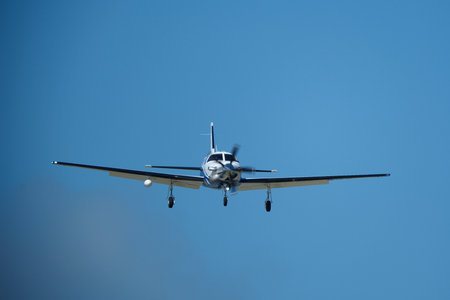 Airplane flying in the blue sky on a sunny day. Side view