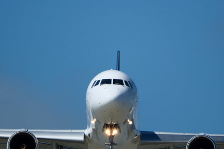 Airplane in the blue sky, closeup of photo with soft focus