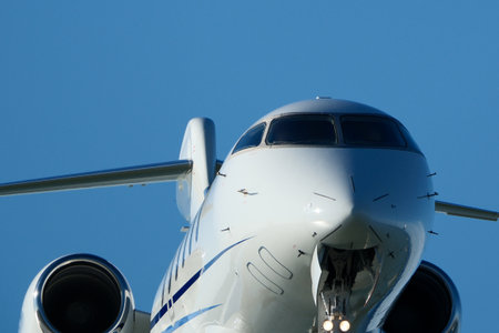 airplane on the background of the blue sky, close-up. Clear Blue Sky and Aircraft Nose. Close-Up of...