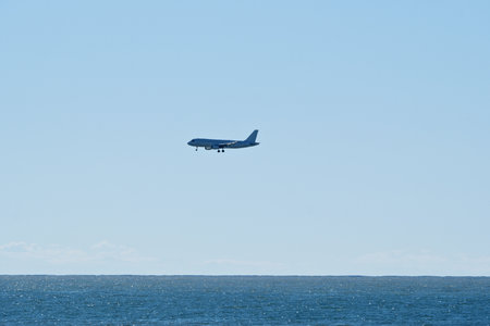 Airliner in flight over the Black Sea. Batumi Airport: Plane at Low Altitudeの写真素材