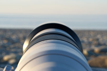 Camera lens on the background of the sea. Close-up.