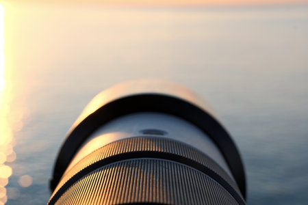 Photographer's Lens on Pebble Beach at Sunset. Camera Lens Aimed at the Open Sea.の写真素材