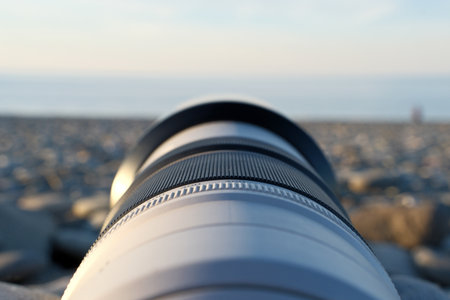 Close-up of a telephoto lens on the beach in the eveningの写真素材