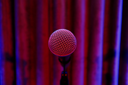 Microphone on stage with red curtains in the background. Selective focus.の写真素材
