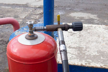 refueling a red gas cylinder