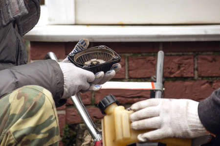 two men repairing a motorcycle plow