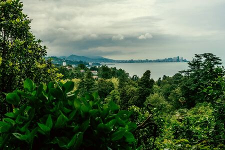 Georgian landscape with sea, sky, green hills and mountainsの写真素材