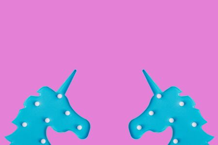 Blue unicorns on pink backdrop.の写真素材